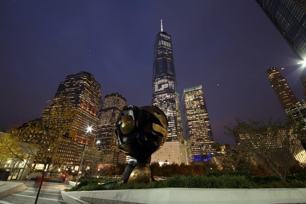 Sculpture with lit skyscrapers at night.